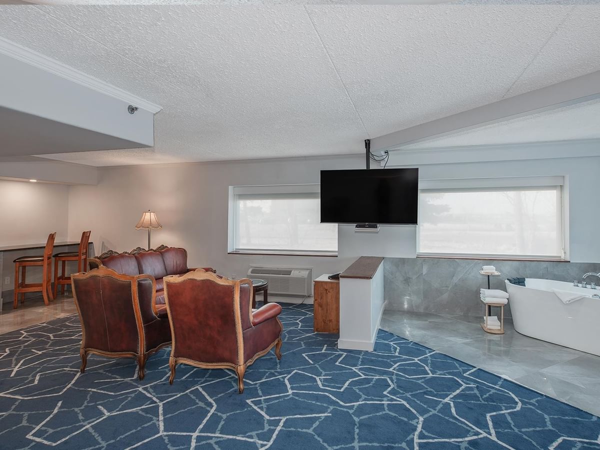 A premium hotel suite with jetted tub and TV.