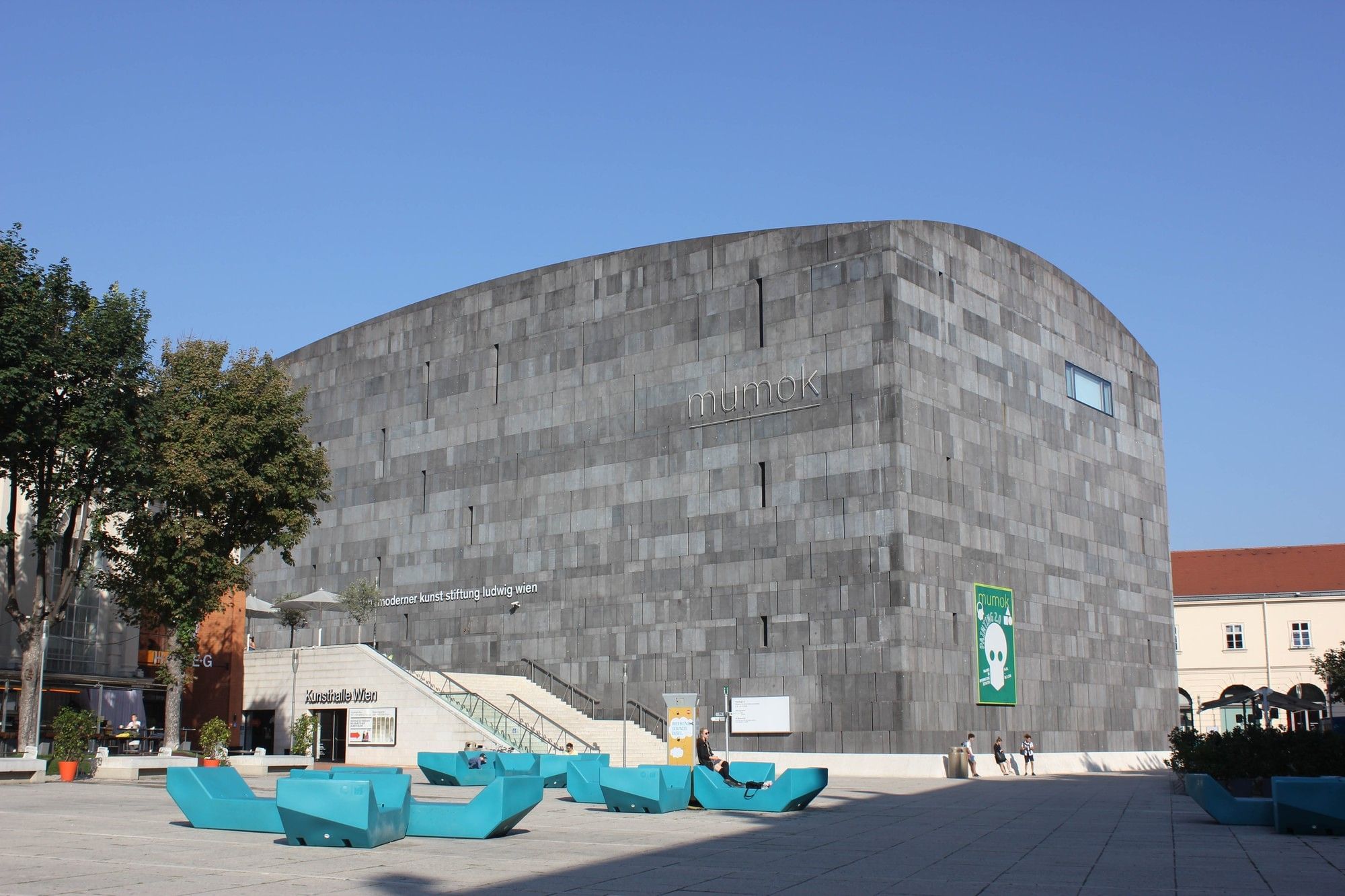 Exterior view of mumok in Vienna’s MuseumsQuartier featuring a striking dark stone façade and contemporary public square design