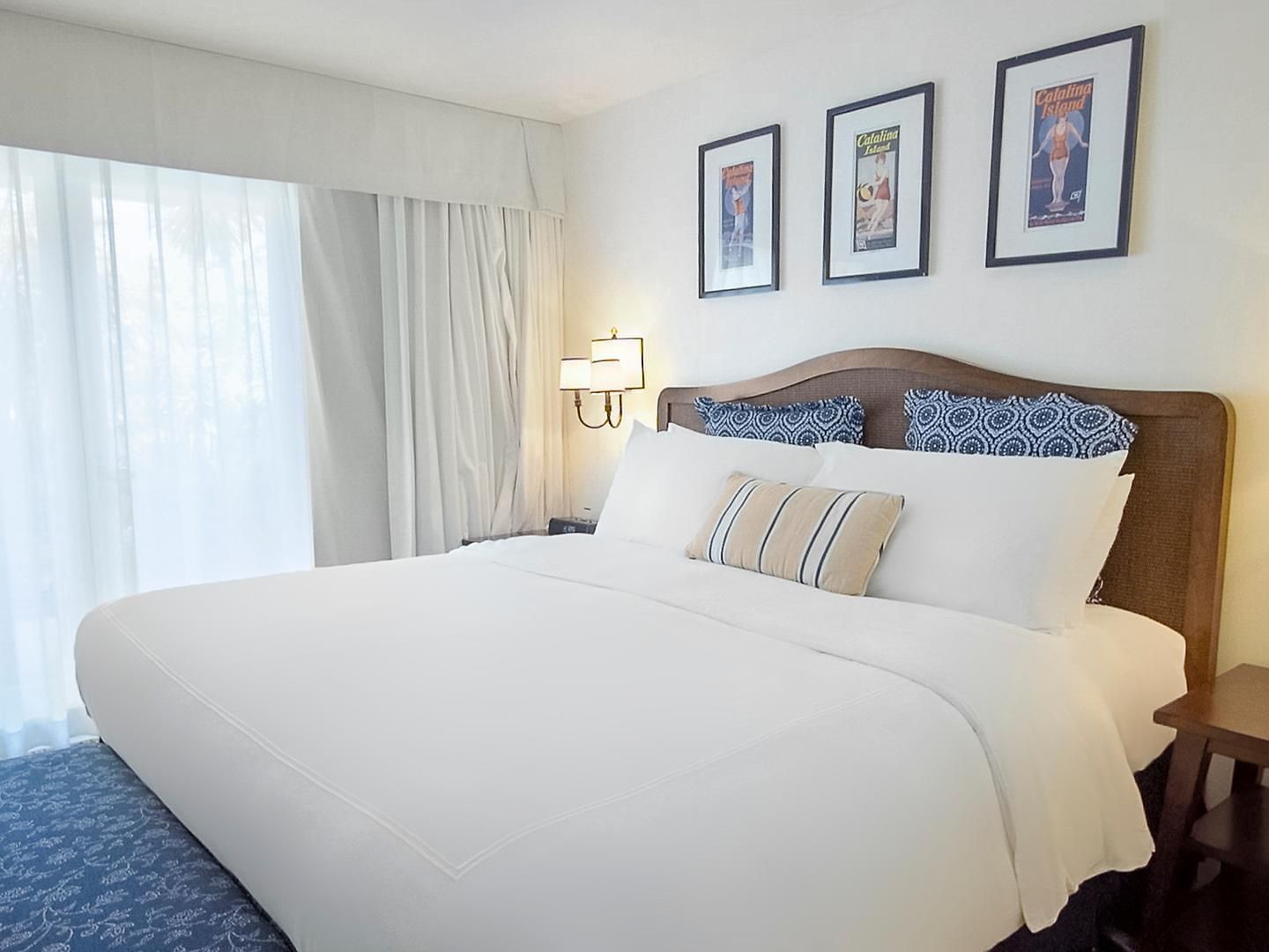 Cozy bed with carpeted floors in Standard King Room at Pavilion Hotel