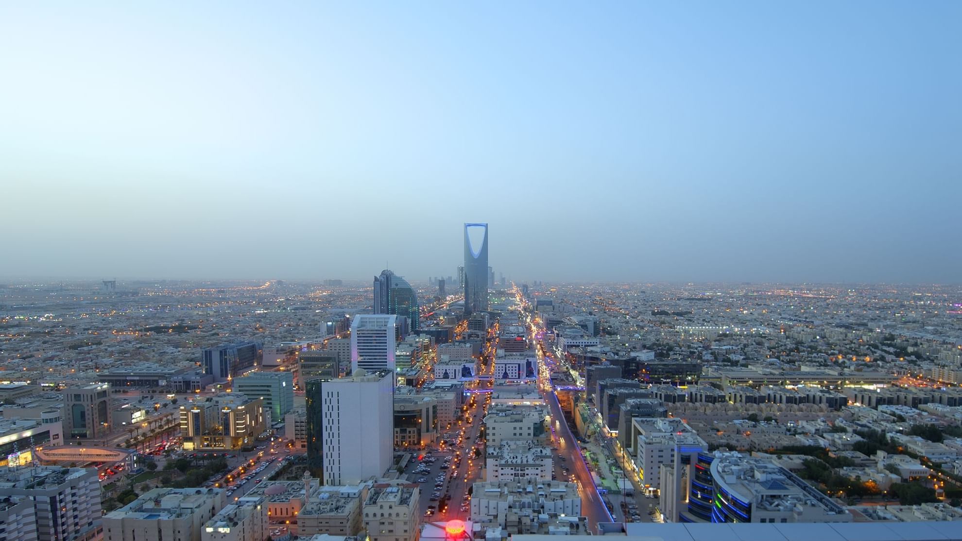 Aerial view of Riyadh from the Warwick Hotels and Resorts, showcasing city lights and the iconic King Abdulaziz Center