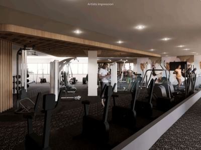 Modern gym with various equipment and people exercising at UniLodge Brisbane City.