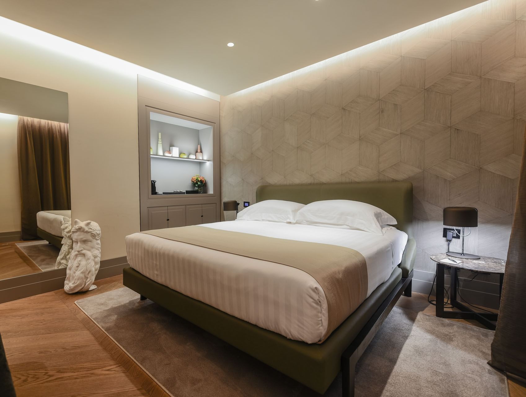 Double bed and nightstand in the bedroom of Garden Suite at Margutta 19