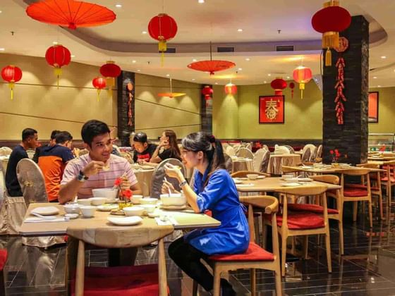 Customers enjoying dishes at Yuan Chinese Cuisine, Lexis Hibiscu
