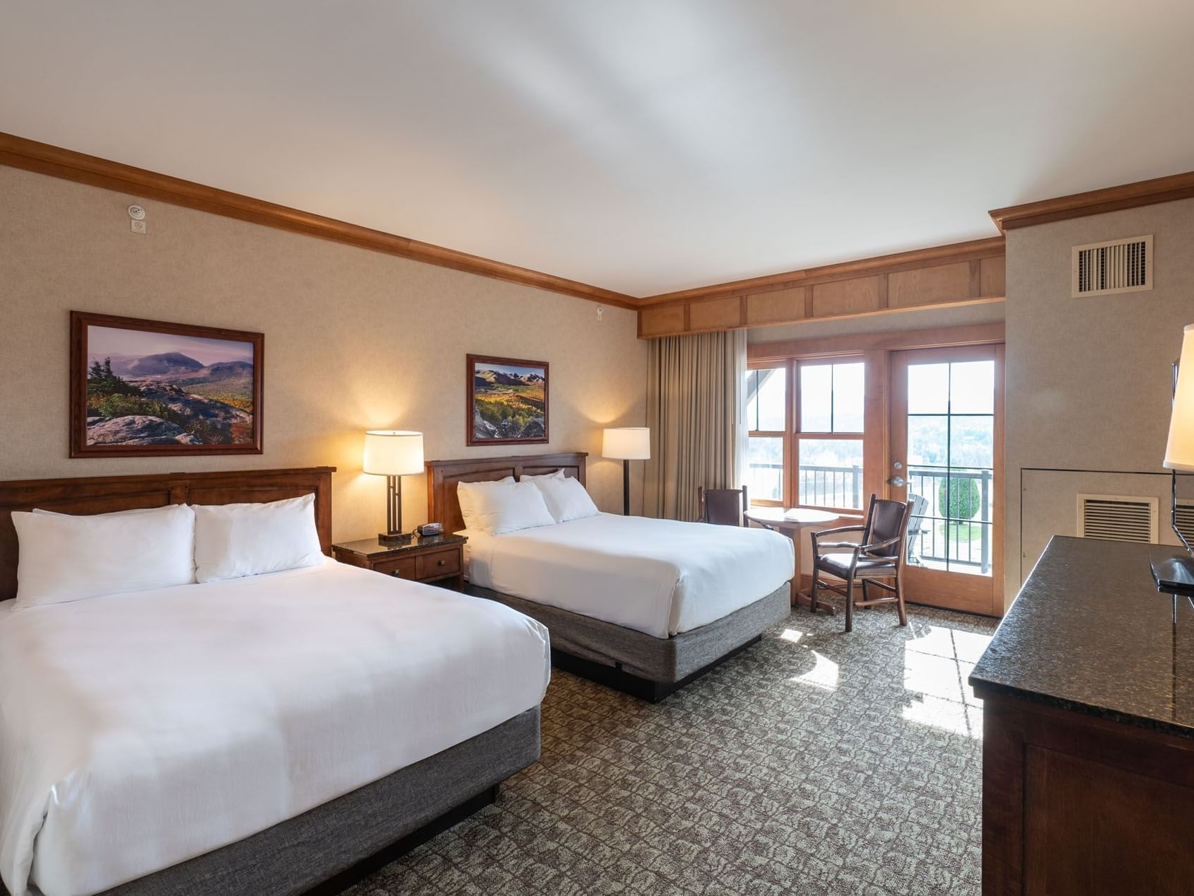Double Queen Room at the Lake Placid Club Grandview, featuring two queen beds and a glass door leading to a private balcony