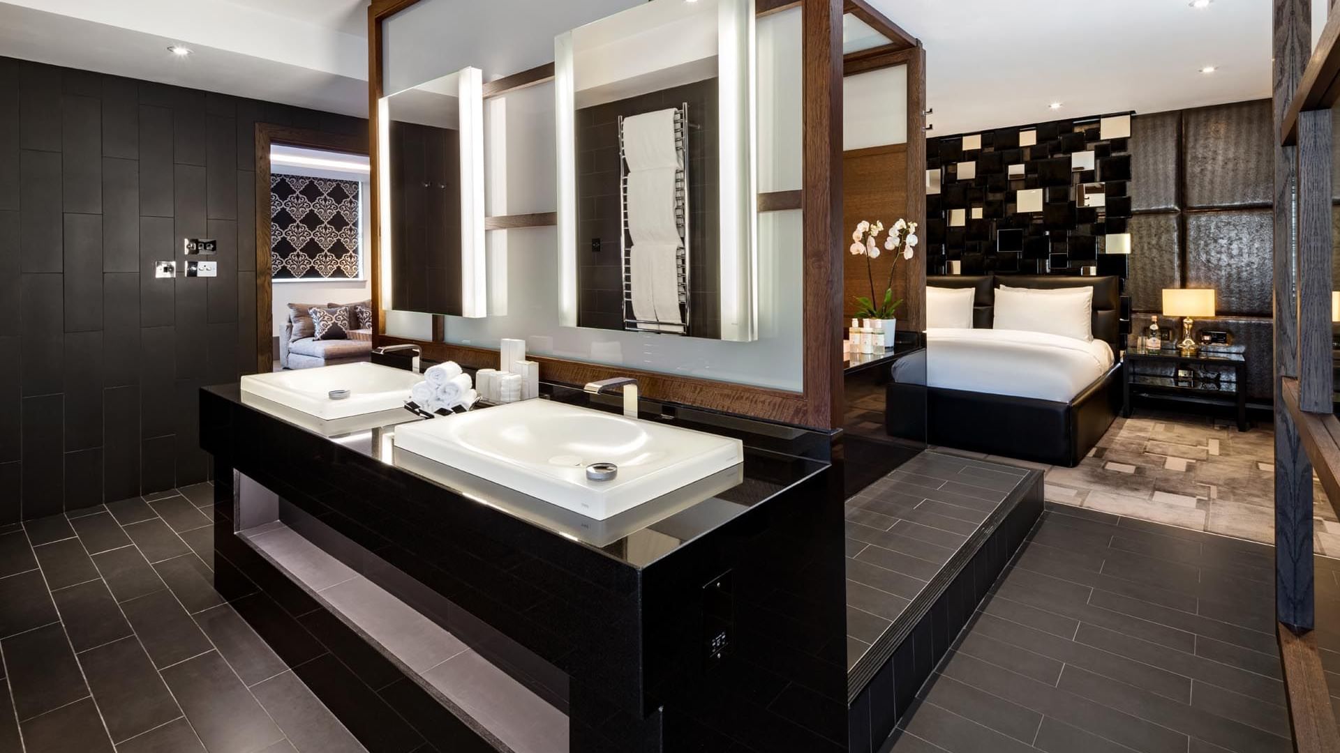 Modern The Ebony Suite at The May Fair Hotel London with sleek design, vanity, illuminated mirrors, and a plush bed
