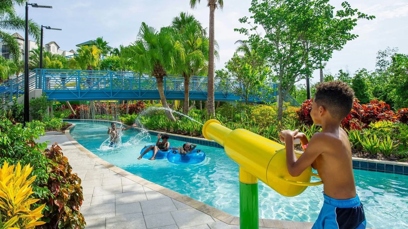 Kid playing with a water gun in Surfari Water Park at The Grove Resort and Water Park