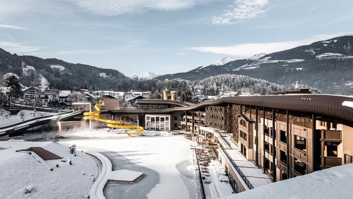 Falkensteiner Family Resort Lido with waterslides and snowy surroundings against mountain backdrop