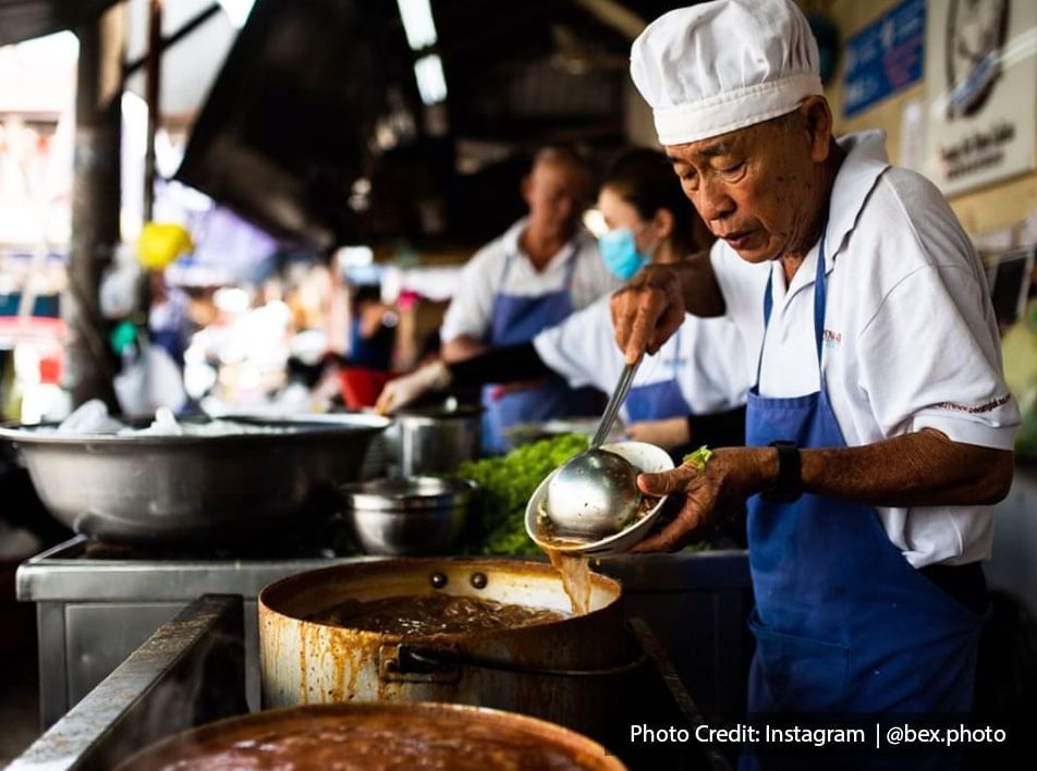 Air Itam Laksa hawker food stall staff is carefully preparing the famous assam laksa for the customers