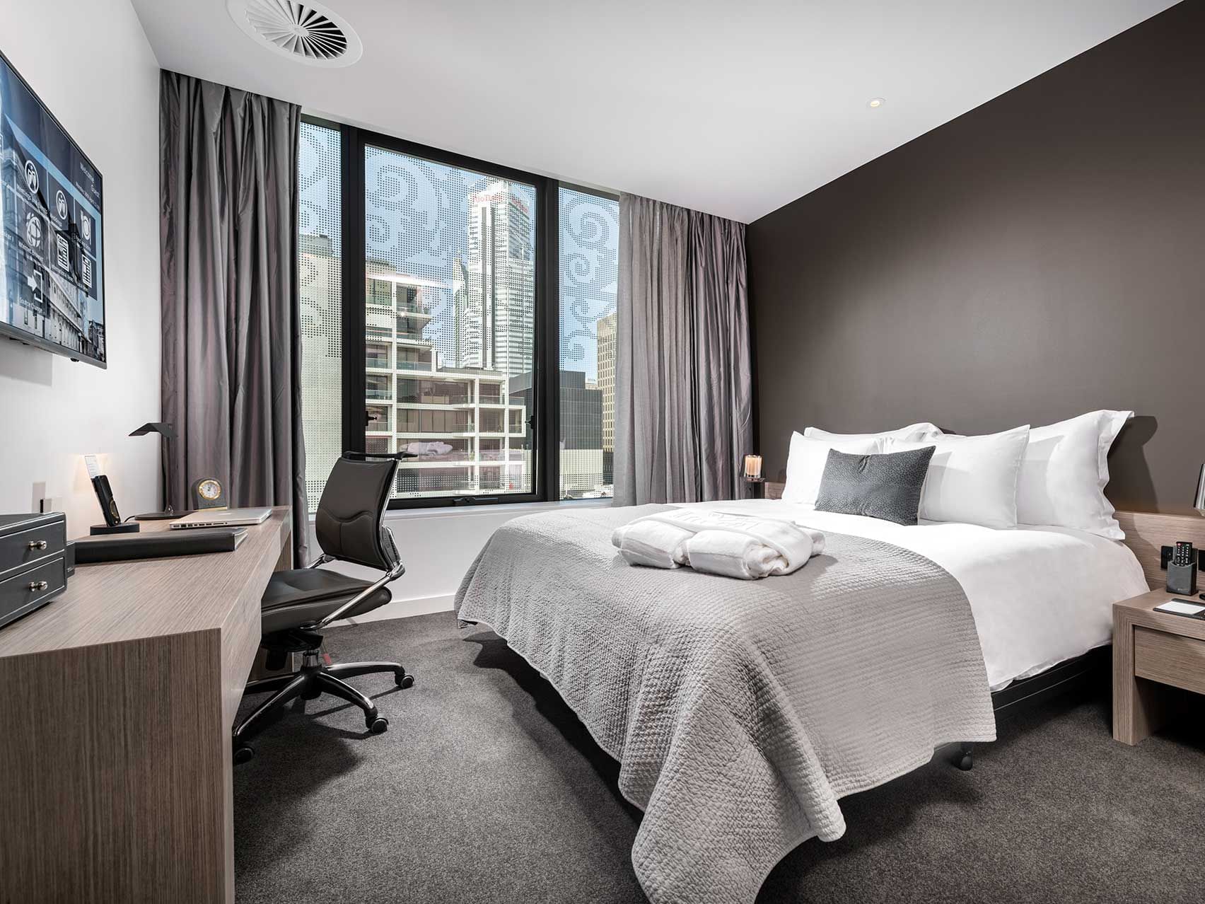 King bed and work area in Contemporary Room with city view at Melbourne Hotel Perth