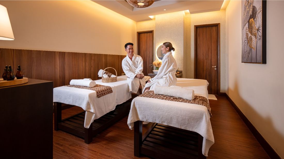 A couple in robes sitting on spa beds in a spa at Sunway Resort