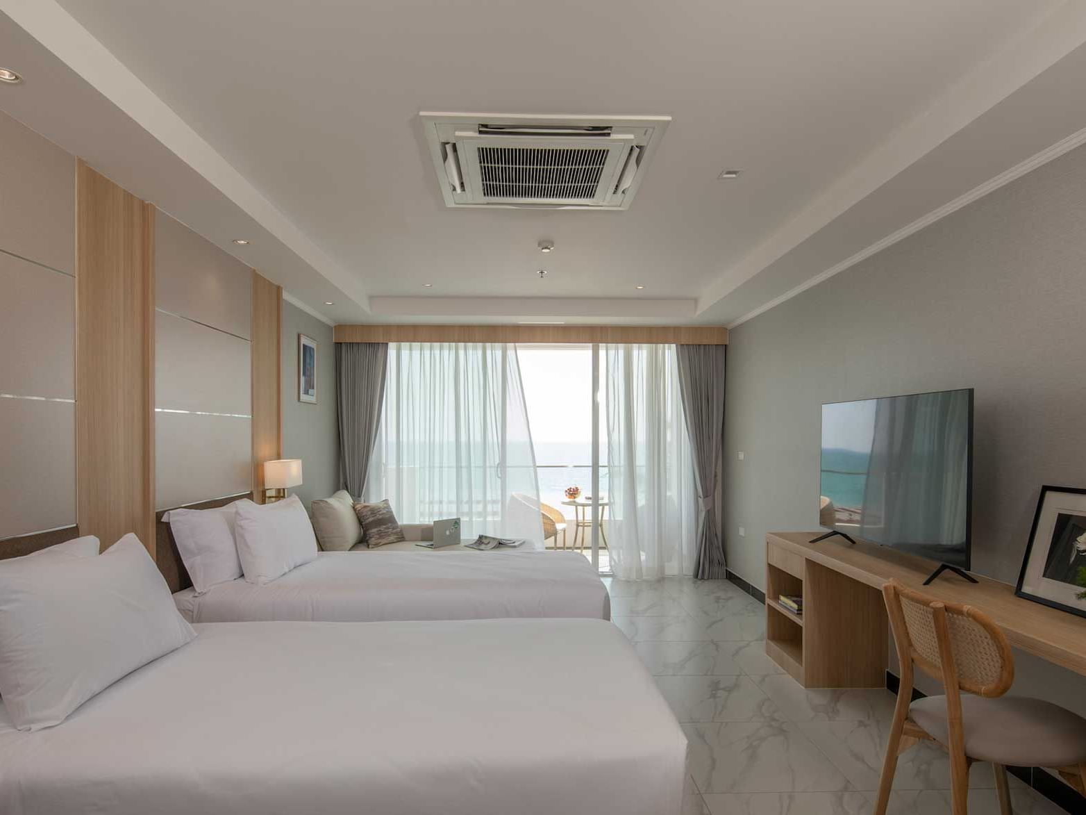 Two beds, work desk & TV in Superior Seaview Room at Eastin Resort Rayong