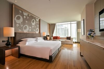 Interior of Premium Deluxe with king bed, TV & comfy sofa at Eastin Hotels