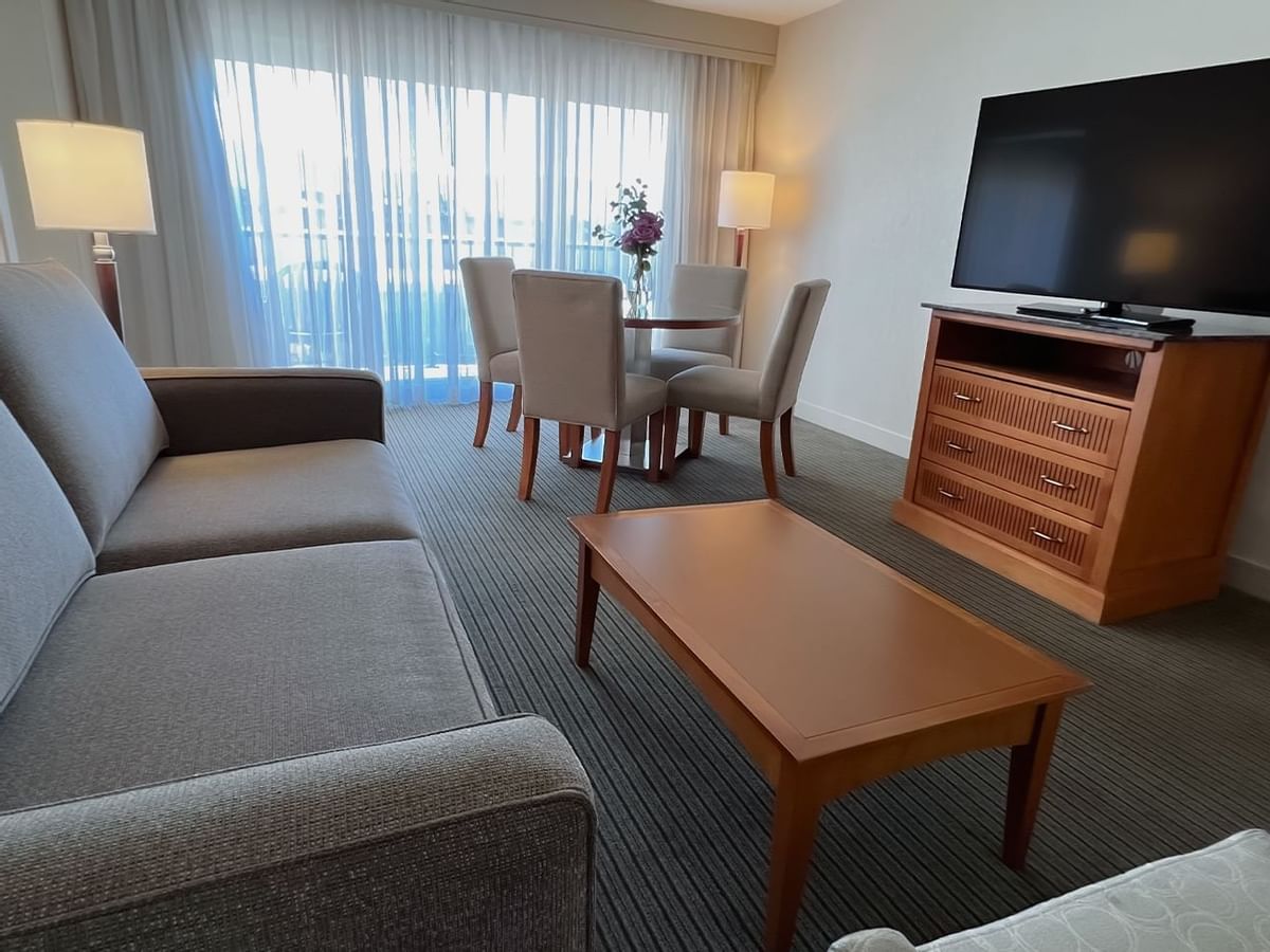 Guest room living area with couch, dining room table, chairs, coffee table