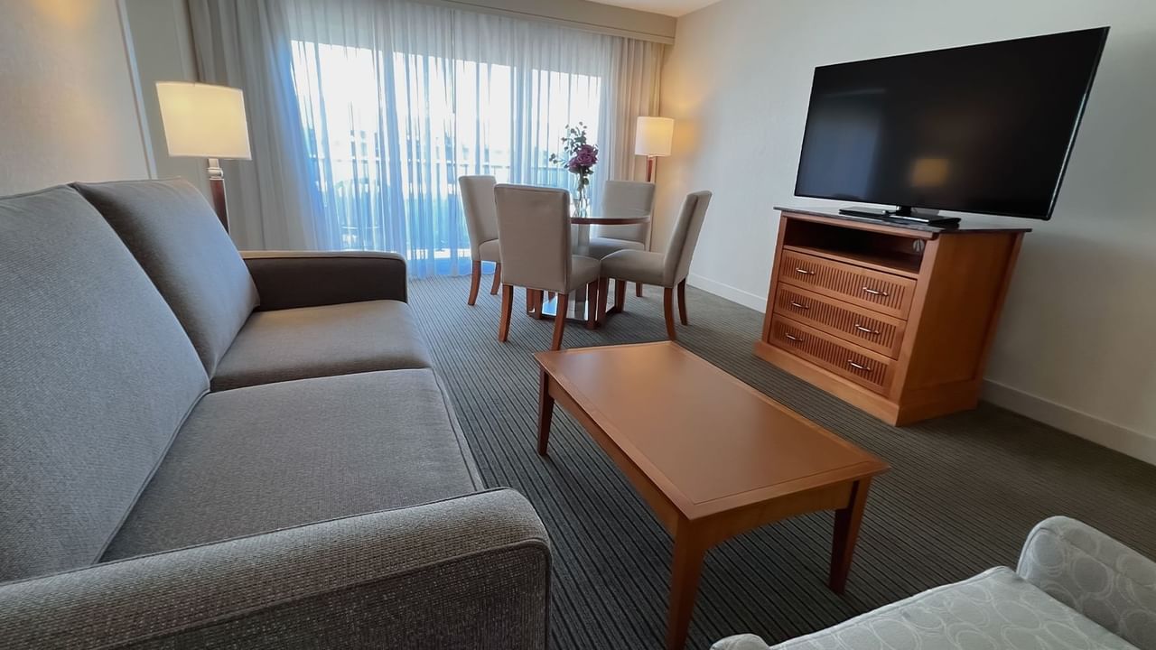 Guest room living area with couch, dining room table, chairs, coffee table