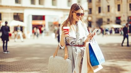 Girl browsing her phone while shopping near Warwick Allerton - Chicago