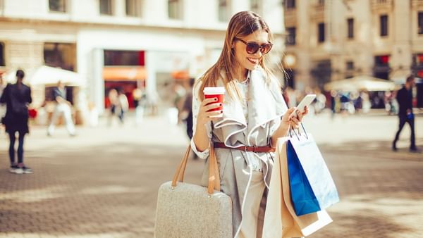 A girl browsing her phone while shopping near Warwick Allerton - Chicago