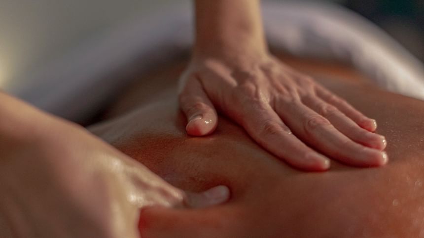 Close-up of a person receiving a back massage in Spa at El Silencio Lodge & Spa