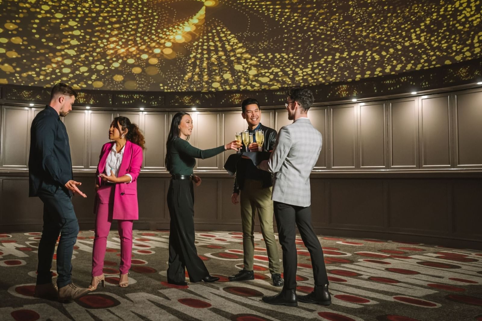 People in smart casual hanging out in a spacious area with carpeted floors at Pullman Albert Park