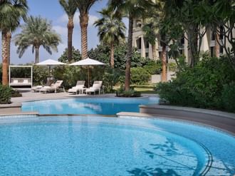 Sunbeds with canopies by the outdoor pool at Palazzo Versace