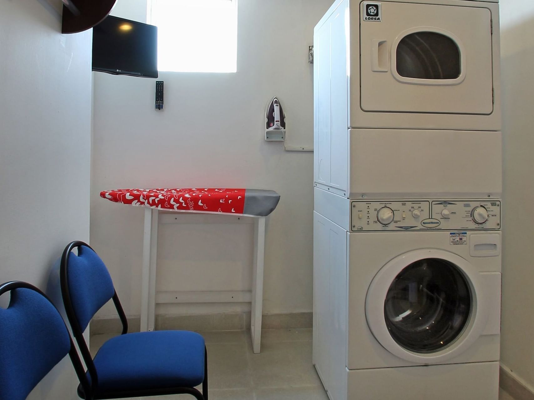 Washing machine, dryer & chairs in Laundry Room at One Hotels