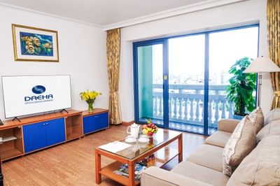 Room with couch, TV & a balcony at Hanoi Daewoo Hotel