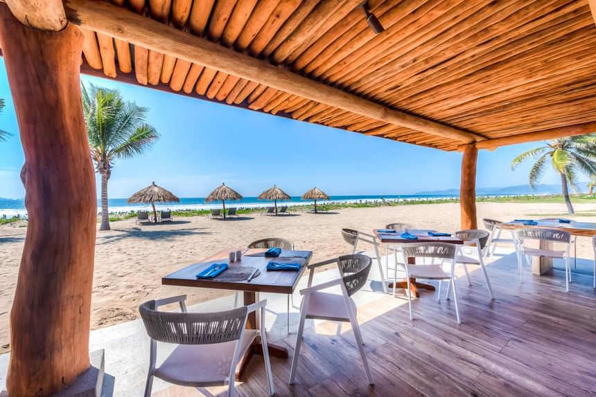 Outdoor dining area with a sea view at Marea Beachfront Villas