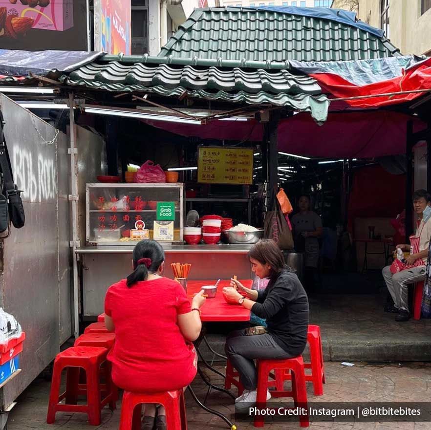 Two ladies dining by a street food stall in Chinatown Petaling Street near Imperial Lexis Kuala Lumpur