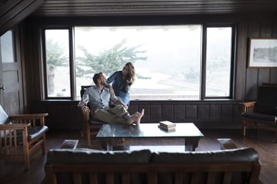 Couple enjoying a relaxing moment in a cabana lounge area with ocean view at Banning House Lodge