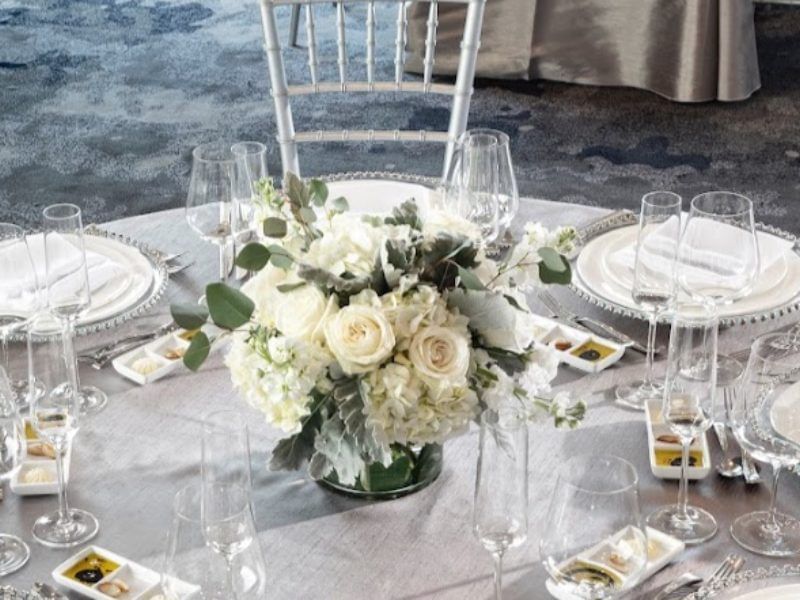 Table setting with floral centerpiece and crystal glassware in Gorges Room at Portland Harbor Hotel