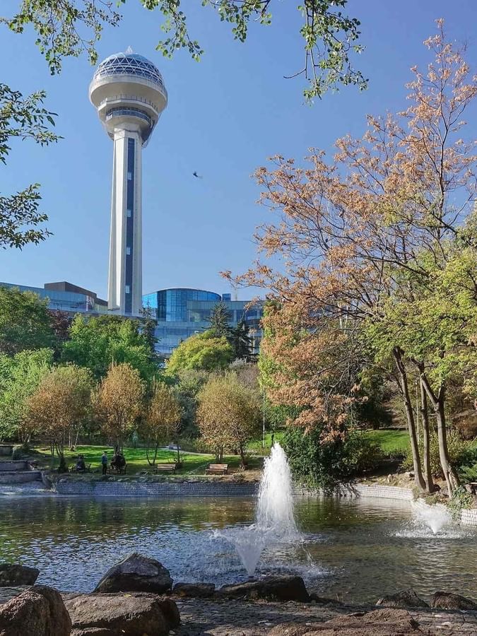 Park pond by a fountain under an Atakule tower surrounding the scenic grounds near Warwick Melrose Dallas