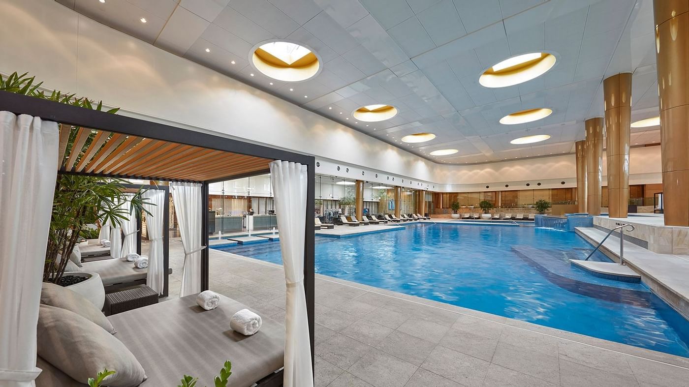 Indoor pool with lounge chairs at Crown Hotels
