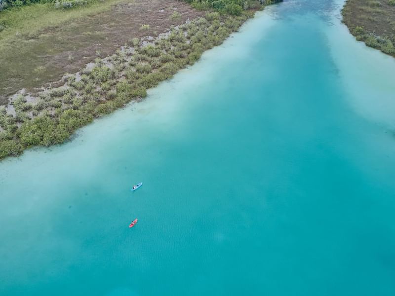 Aerial view of two people kayaking in Bacalar Lagoon near The Explorean Kohunlich