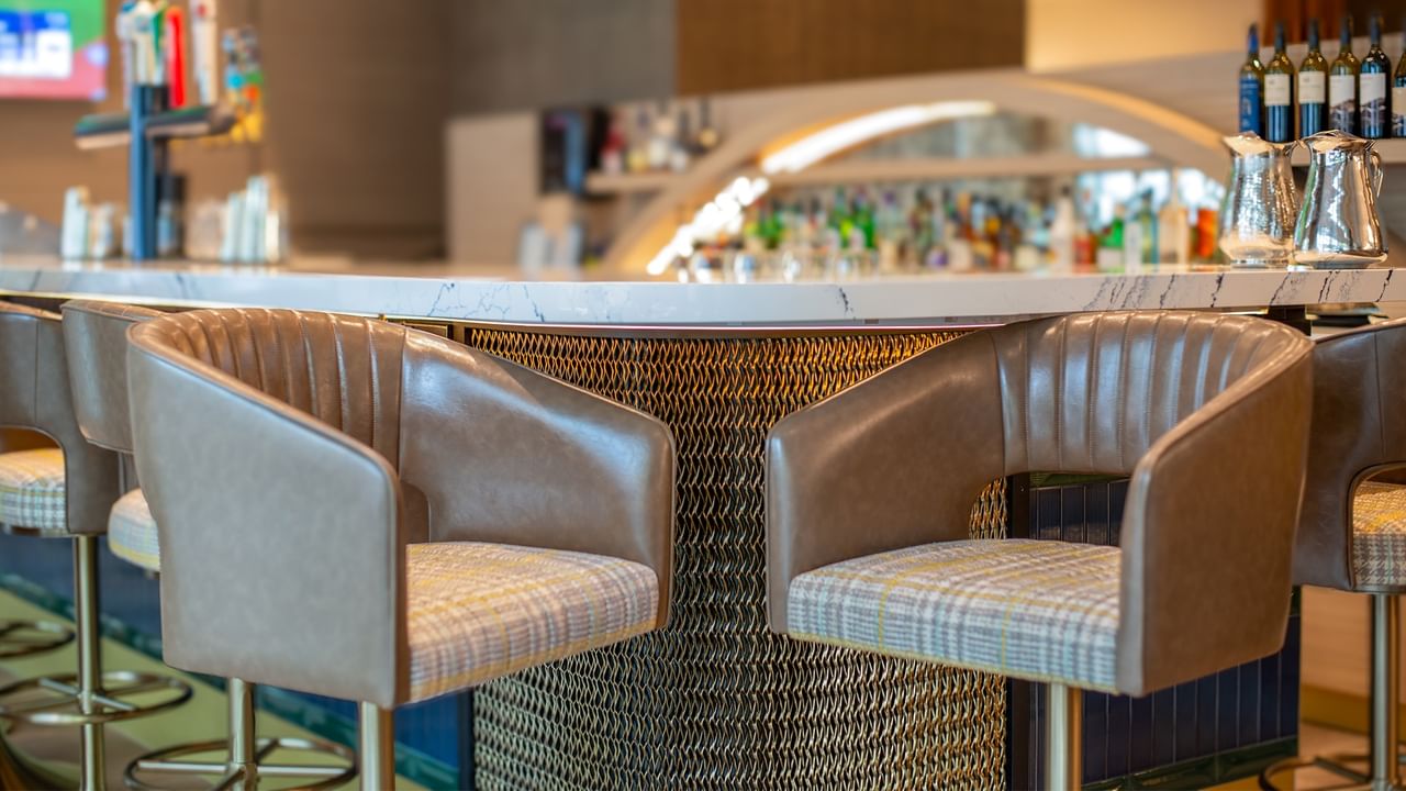 Bar seating with chairs and white countertop.