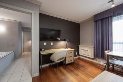 Jacuzzi Suite with work desk, chair and flat-screen TV at Sandman Hotel & Suites Winnipeg Airport, Winnipeg airport hotels