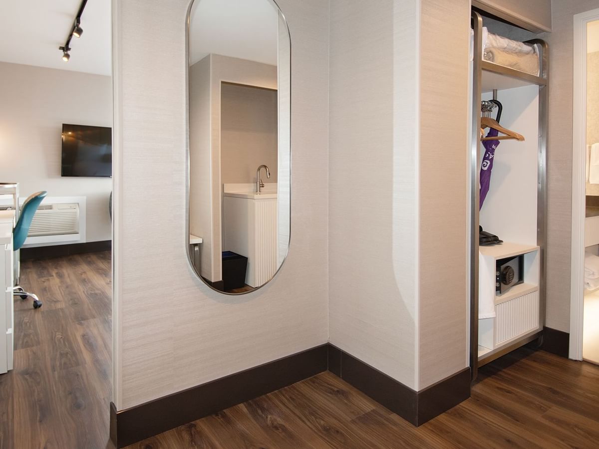 Hotel guestroom hallway to bathroom with a mirror.