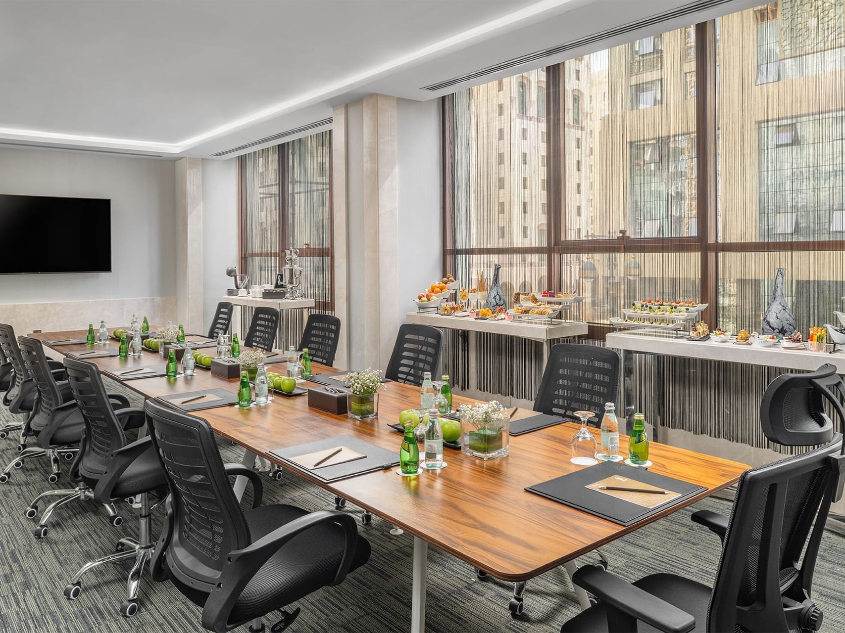 Long table & TV in a Meeting room, Elaf Al Taqwa Hotel