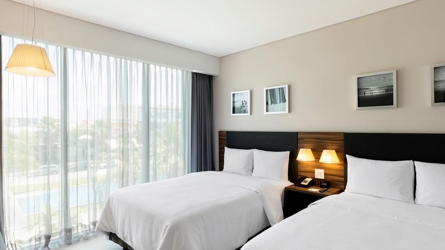 Superior Room Dos Camas at Fiesta Inn Express Cancún Cumbres with two beds by window, best places to stay in cancun