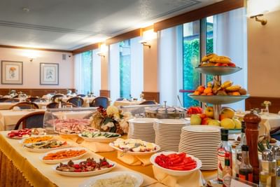 Breakfast buffet table filled with various foods in the Breakfast Room at Hotel Crivi's in Milan