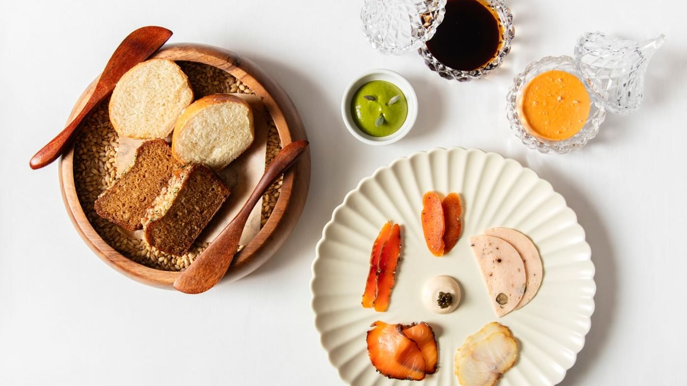Delicious charcuterie board with assorted bread and savory sauces at Tom Brown, The Capital, Warwick Hotels and Resorts
