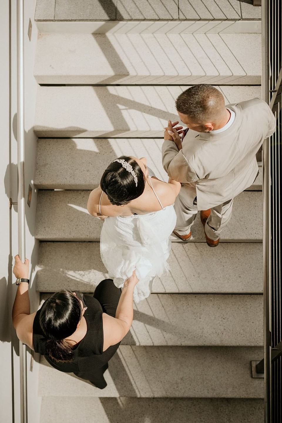 Couple holding hands on a stairway at Isla Verde Weddings