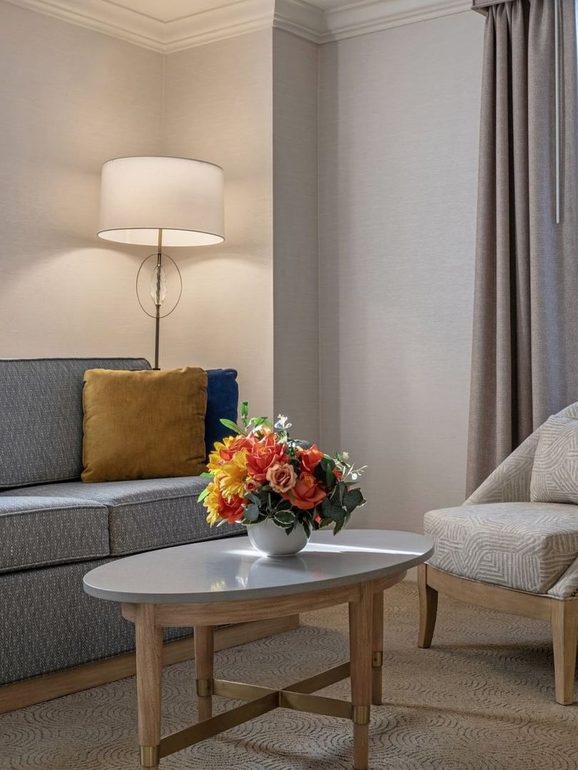 Sofa with coffee table near floor lamp in Executive Two Queen Beds at Warwick Allerton Chicago