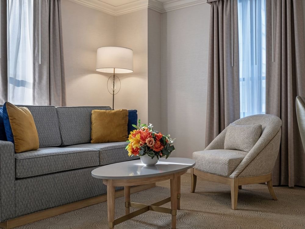 Sofa with coffee table near window in Executive Two Queen Beds at Warwick Allerton Chicago