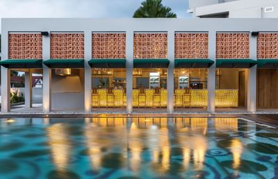 Bar with stools by the outdoor pool at Eastin Hotels
