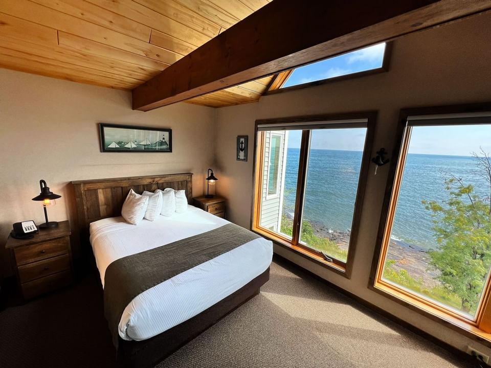 Queen bed in Lakeside Guestroom, Bluefin Bay Family of Resorts