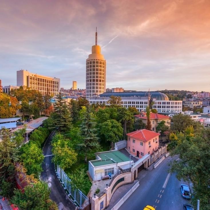 Panoramic cityscape view with prominent buildings and lush greenery near Warwick Ankara