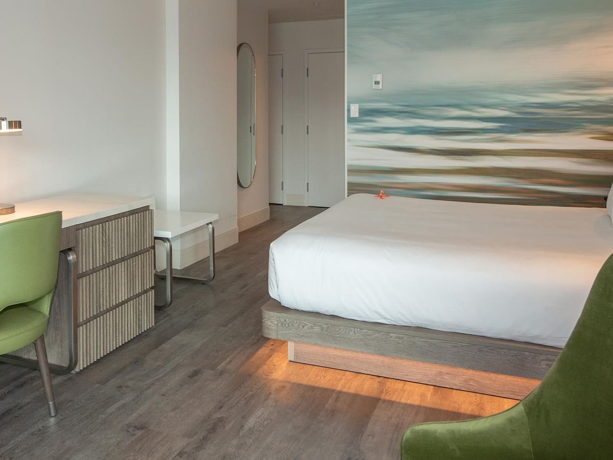 Elegant hotel room with King bed and work desk.