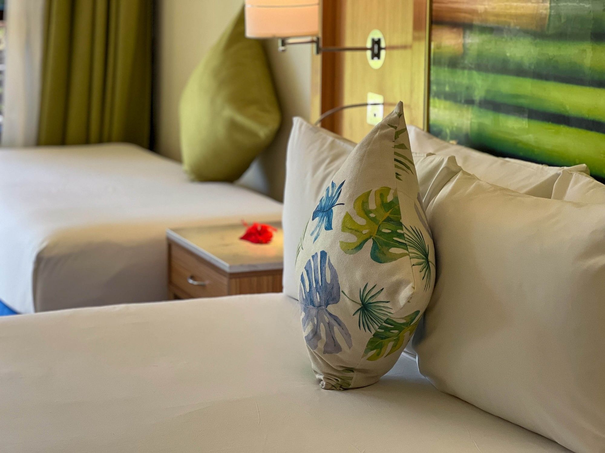 Comfort room with a floral pillow and a nightstand at Naviti Resort Fiji Coral Coast