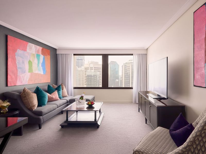 TV lounge area with wall art and plush seating in Signature Suite at Sofitel Brisbane Central