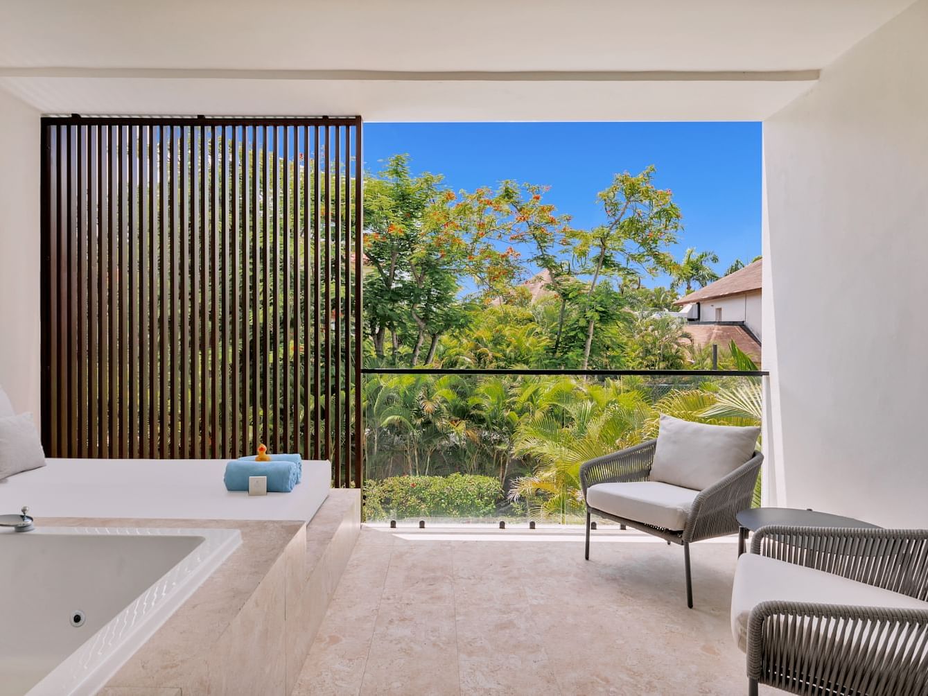 Bathtub by the spa bed and seating area in Premium Garden View room at Live Aqua Punta Cana