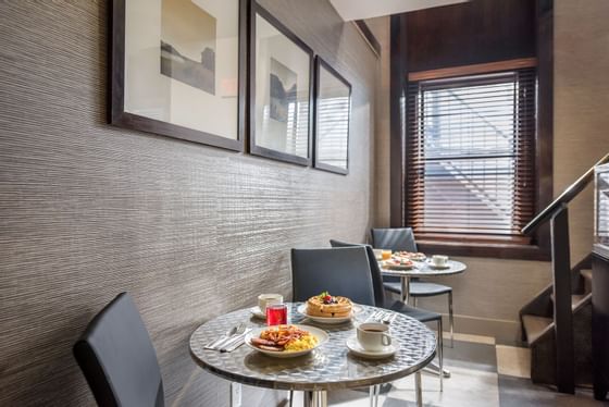 two tables with plates of hot breakfast